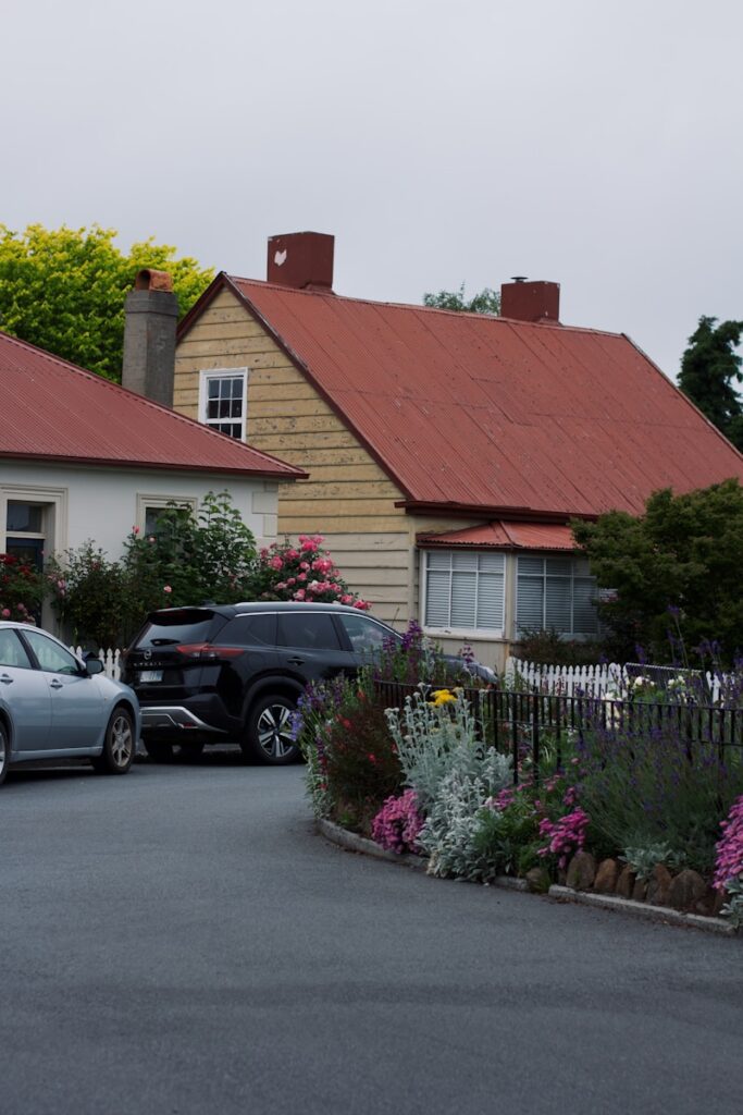 A couple of cars parked in front of a house